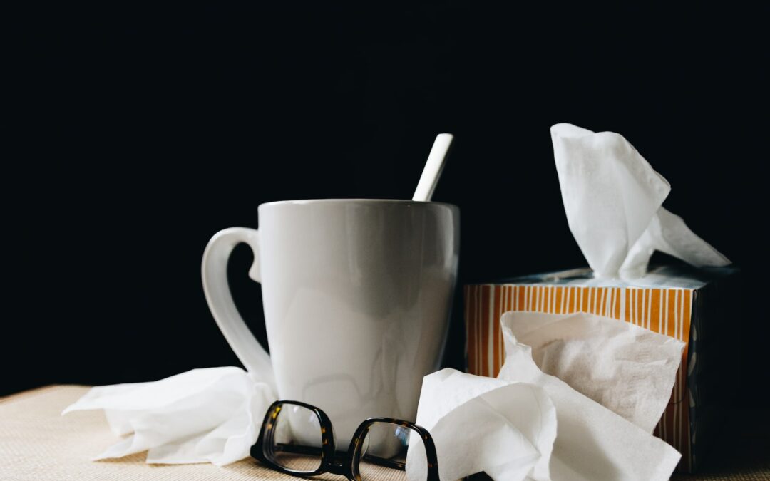 white ceramic mug on white table beside black eyeglasses